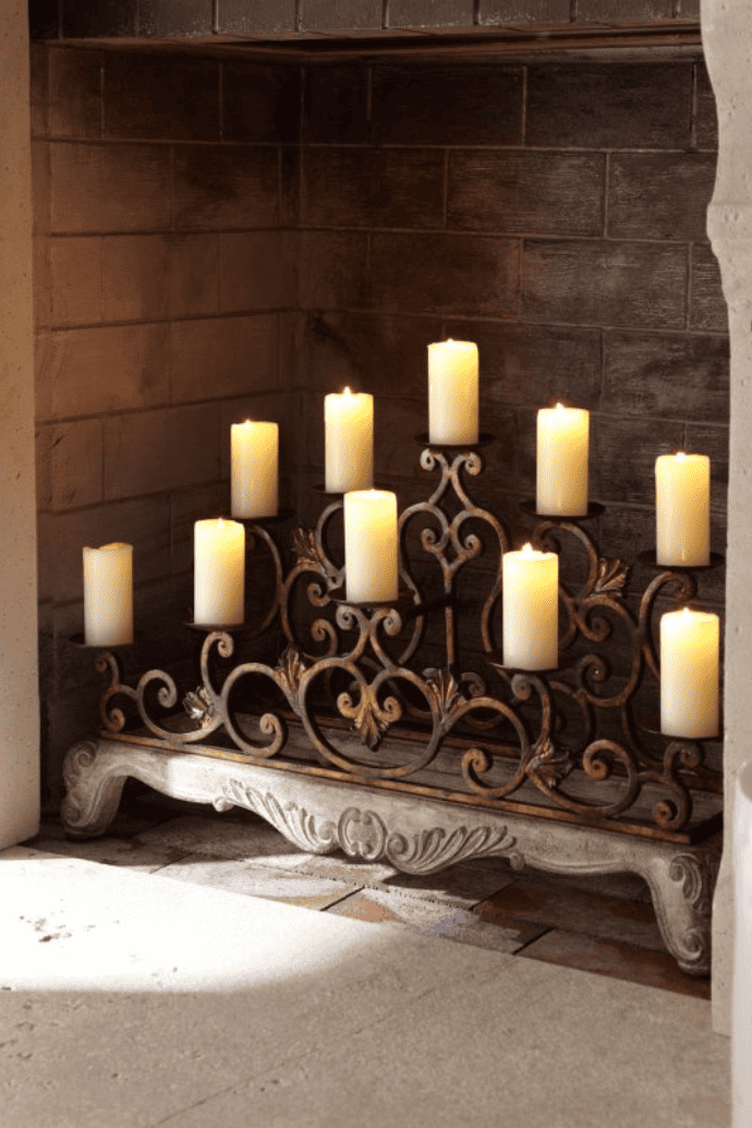 Decorate a fireplace with flameless candles, & a metal candelabra