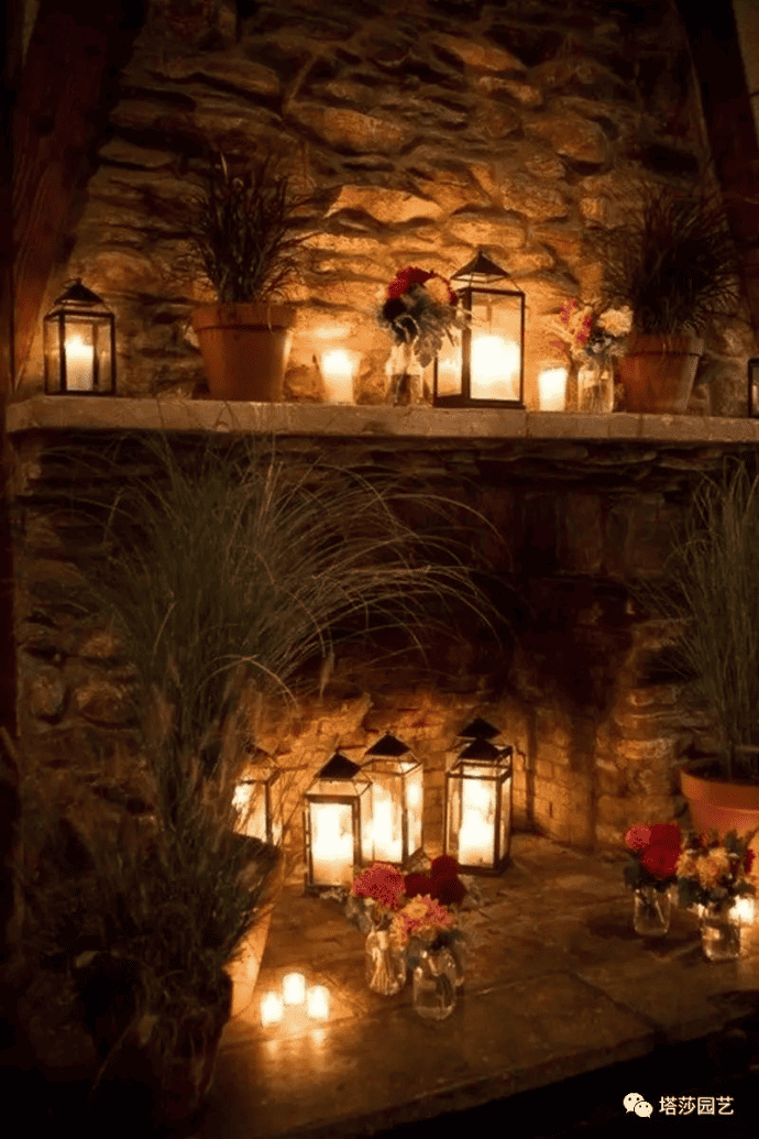 Decorate a fireplace with flameless candles, flowers, greenery, candle holders, lanterns