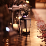 Flameless candles for wedding aisles with lanterns, flowers, rose petals