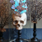 Classy Halloween decor ideas using decorative skull with blue butterflies in a cloche