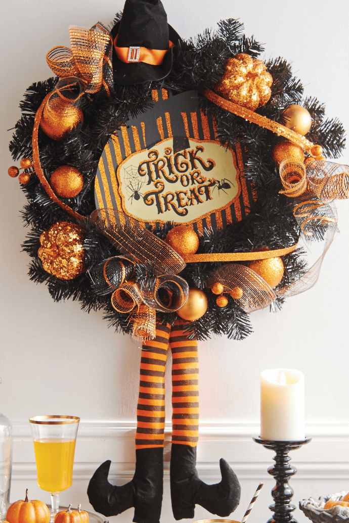 Cute ways to decorate a Halloween wreath with witch legs, witch hat, pumpkins and ribbons