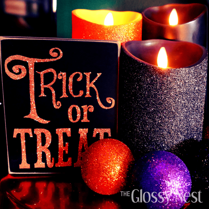 Cute ways to decorate for Halloween with black & orange glitter flameless candles and a Trick or Treat box sign