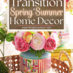 A wicker basket holds a vase with vibrant pink and yellow roses, alongside a lit candle and small books. Text reads, "How to Transition Spring & Summer Home Decor." Discover decorating ideas for each month on our website.