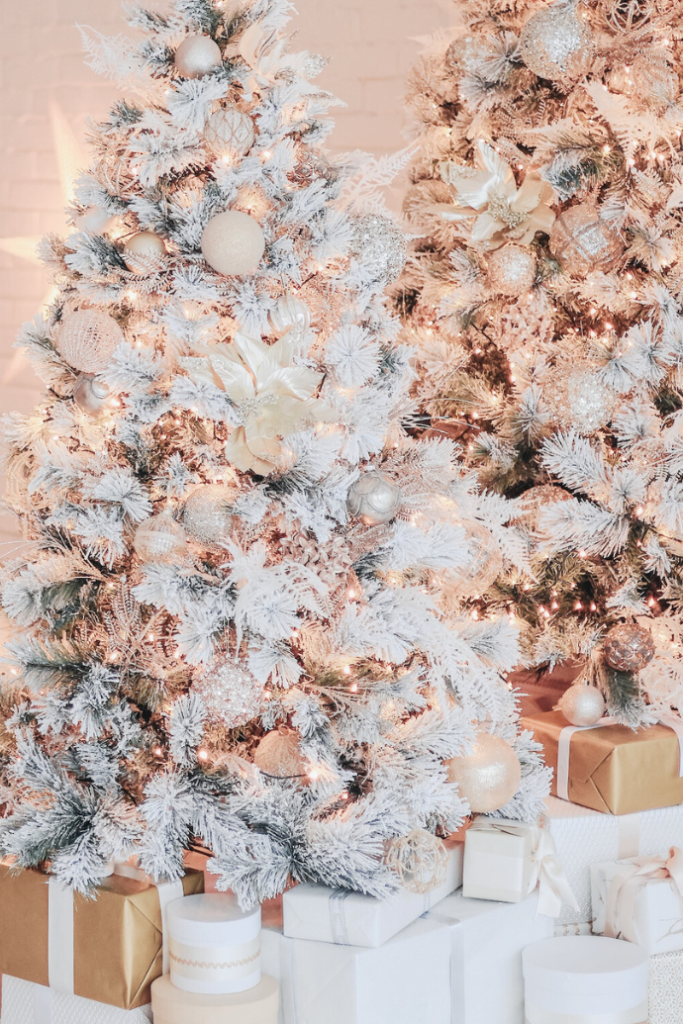 flocked Christmas trees with presents underneath