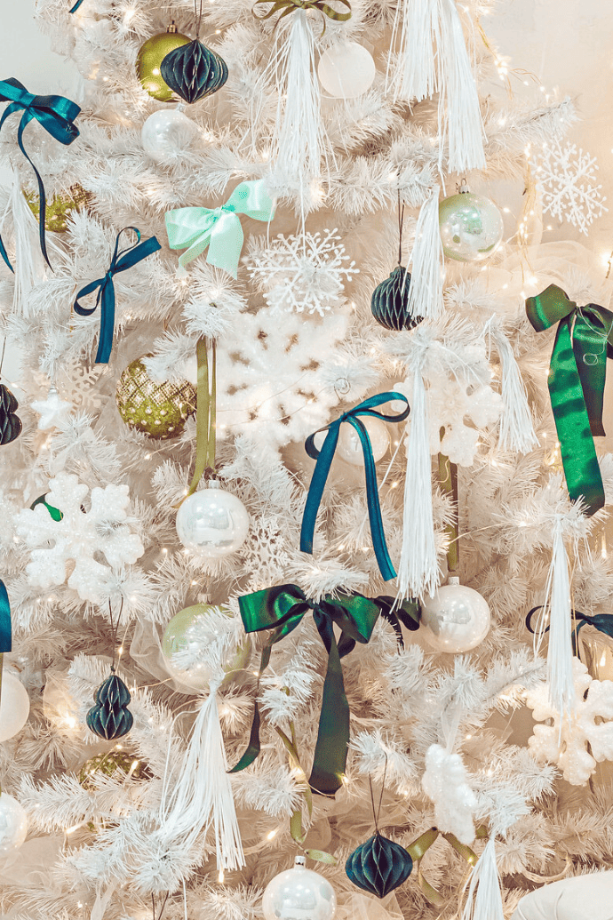 all white Christmas tree with green, gold ornaments