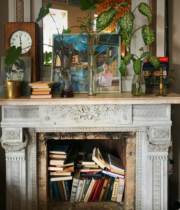 books in an empty fireplace