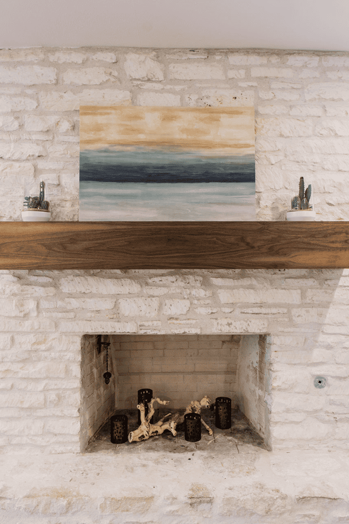 empty fireplace with candle holders, driftwood