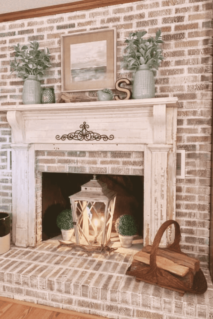 lantern, boxwood plants in a non working fireplace