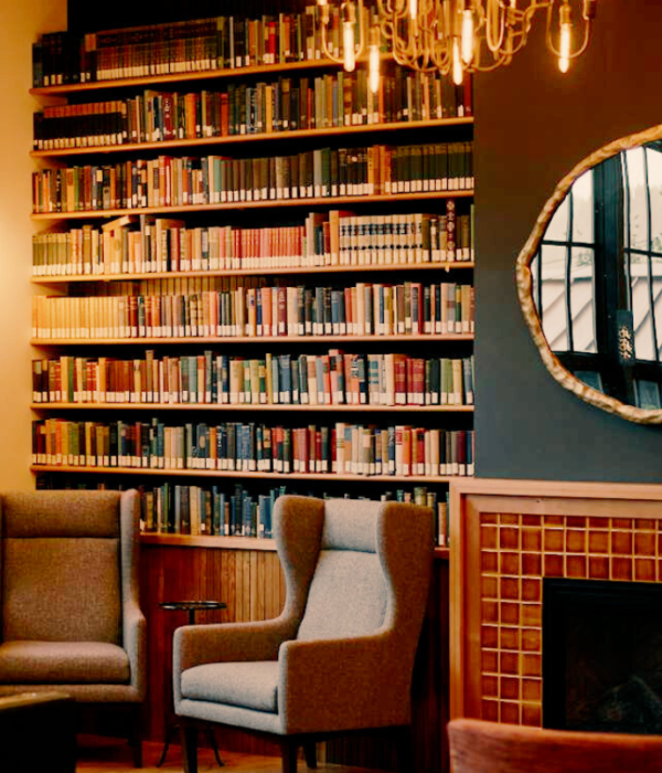 bookcase with books next to fireplace