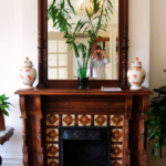 antique wood large mirror on a fireplace mantel