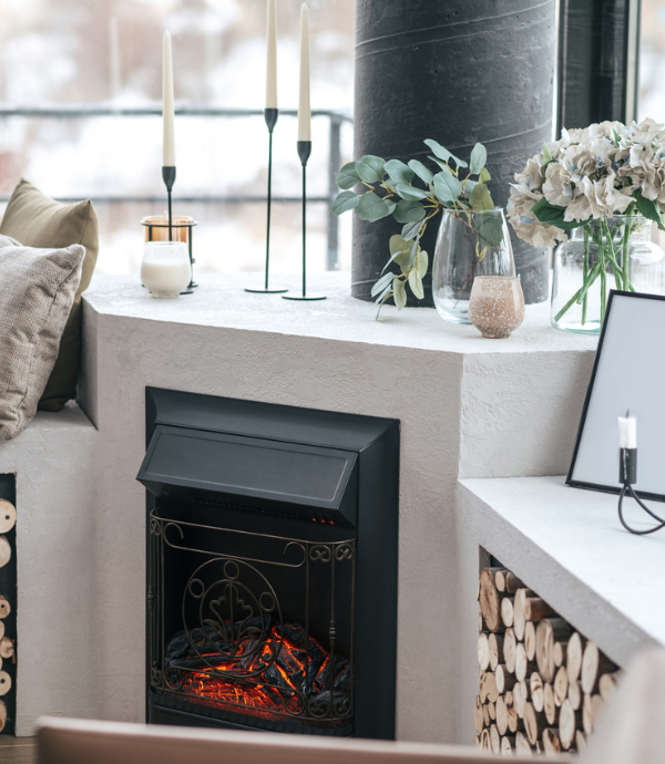 corner fireplace with built ins, candles, logs