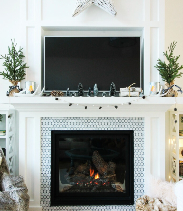 fireplace above mantel with small christmas decorations