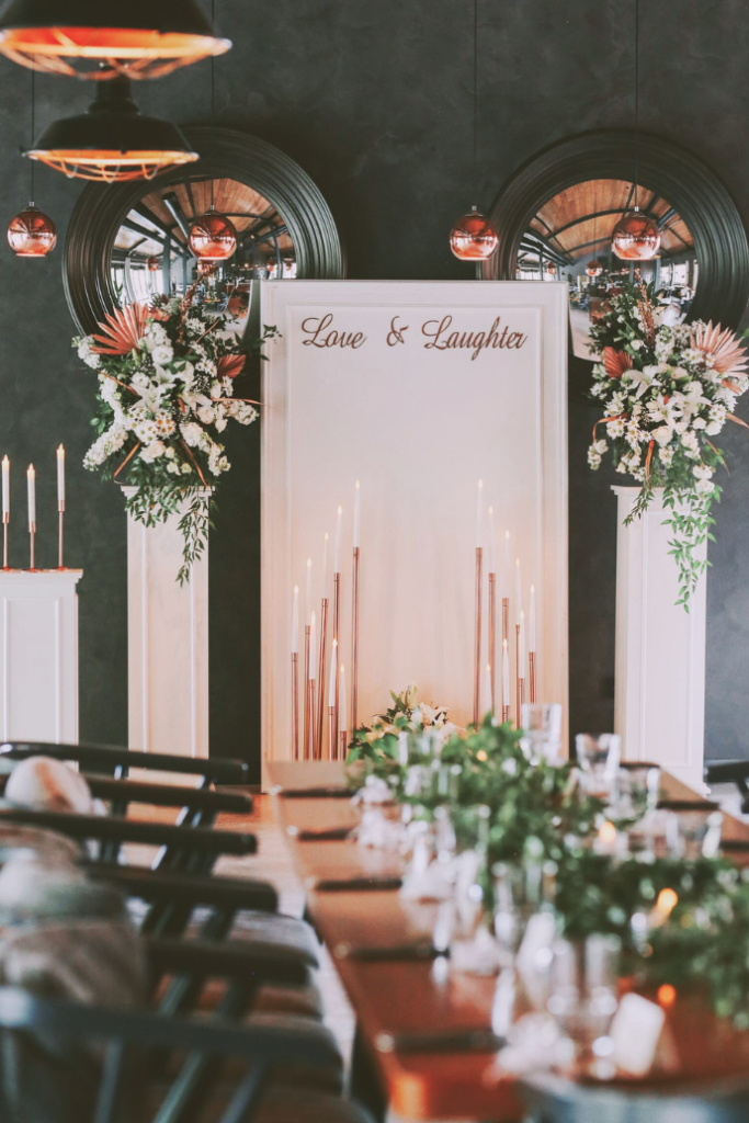 love and laughter wedding sign for reception on white backdrop