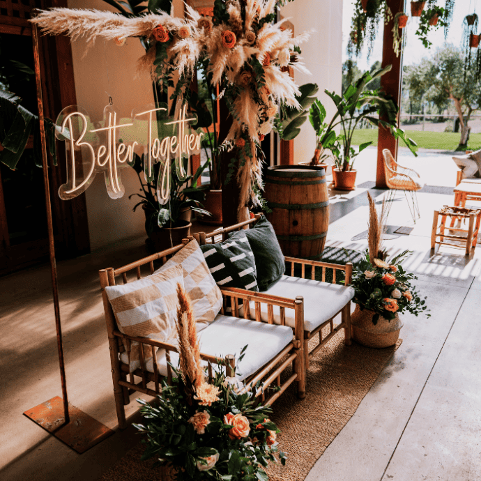 better together wedding neon sign, boho decorations, chairs, arch