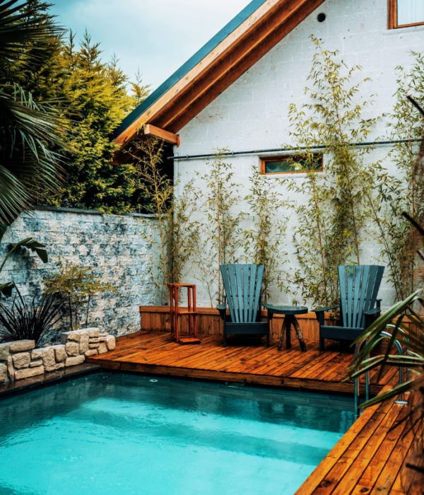 chairs, tables on small pool deck in backyard